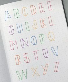 an open notebook with colorful letters and numbers on it