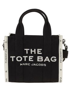 Travel tote made from cotton canvas by Marc Jacobs. This structured silhouette includes a zip top closure, dual top handles, and a removable adjustable shoulder strap. The front displays bold printed text, adding to its modern appeal.

- Dimensions: 30cm x 25cm x 12cm  
- Material: 100% cotton canvas  
- Contrast print detail: THE TOTE BAG MARC JACOBS Marc Jacobs Handbag, Marc Jacobs Tote, Small Tote Bag, Marc Jacobs Bag, The Tote Bag, Roger Vivier, Canvas Handbags, Medium Tote, Small Tote