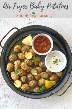 an overhead view of a plate of food with potatoes and ketchup on the side