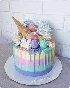 a colorful cake with ice cream and candies on top