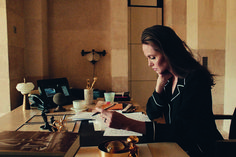 a woman sitting at a desk with headphones on