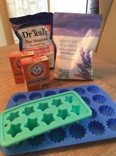 the ingredients to make an ice tray cake are displayed on a wooden table, including baking supplies