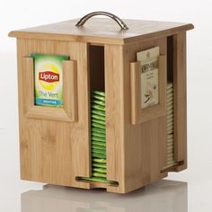 a wooden box with magazines in it and a handle on the door that is open