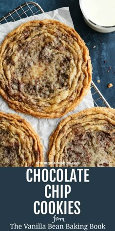 three chocolate chip cookies on top of a cooling rack