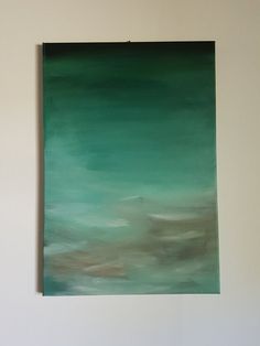 a painting hanging on the wall in a room with white walls and green paint over it