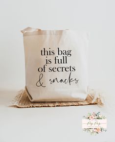 this bag is full of secrets and smiles tote bag with black lettering on it