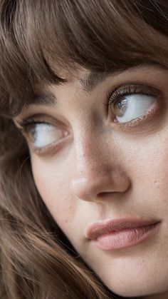 a close up of a woman with blue eyes