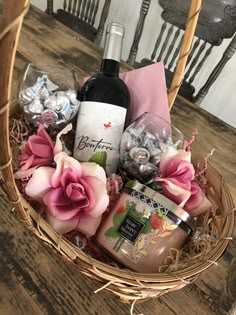 a basket filled with wine, chocolates and candy