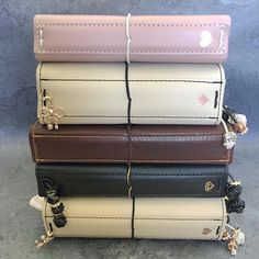 four different colored purses stacked on top of each other in the same row,