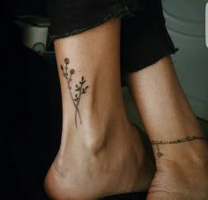 two people with tattoos on their feet and one has a flower tattoo on the ankle