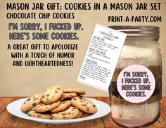 a mason jar filled with cookies next to a plate of cookies