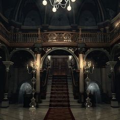 an empty hall with stairs and chandelier