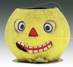 a yellow pumpkin with blue eyes and red mouth is shown in front of a white background