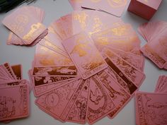 pink and gold playing cards on a table