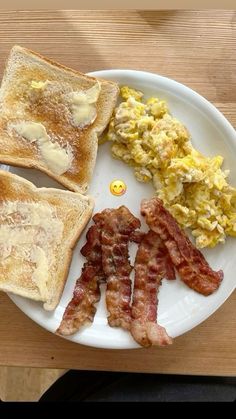 a white plate topped with toast and bacon