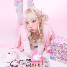 a woman laying on the ground next to some toys