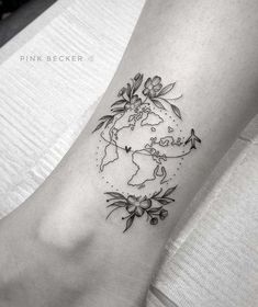 a small world map with flowers on the side of the ankle tattoo designs for women