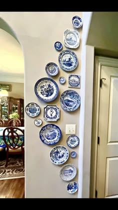 blue and white plates are hanging on the wall