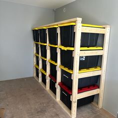 the shelves are filled with black and yellow bins