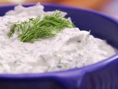 a blue bowl filled with sour cream and dill