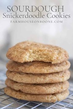 a stack of cookies sitting on top of a cooling rack with the words sourdough snickkerdoodle cookies