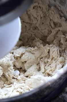 a mixer filled with dough sitting on top of a counter