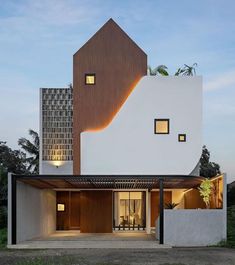 the modern house is made up of white and brown blocks, with windows on each side