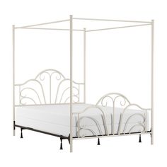 a white metal bed frame with four posts