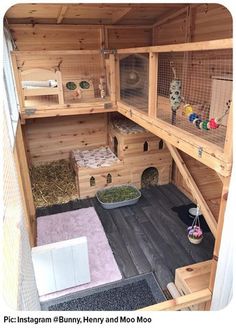 the inside of a wooden bird house with lots of cages and other things in it