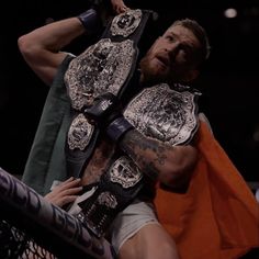 a man with a beard holding a wrestling belt