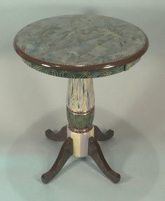 a round table with two pedestals on each side and an ornate design on the top