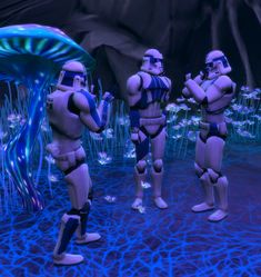 three star wars action figures standing in front of a jellyfish, with blue lights