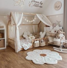 a child's bedroom decorated in white and pink with teddy bears on the floor