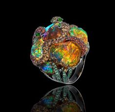 Lydia de Courteille, "Jardins de Xochimilco", snake ring, blackened white gold, rubies, sapphires, tsavorites, diopsides, Mexican fire opals. Fire Opals, I Love Jewelry, Gem Stones, Gems And Minerals, Opal Ring, Gems Jewelry, Opal Jewelry, Pretty Jewellery, Opal Rings