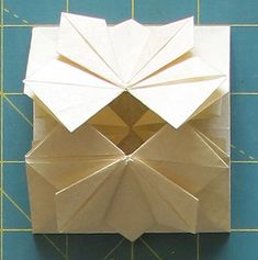 an origami piece on a cutting board