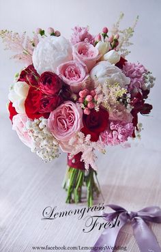 a bouquet of pink and red flowers on a table