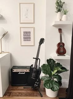 an electric guitar sits on a table next to a potted plant and other musical instruments