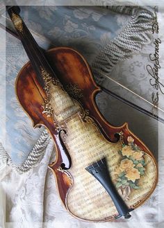 an old violin is laying on the bed