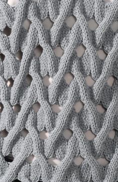 a crocheted blanket is shown in grey