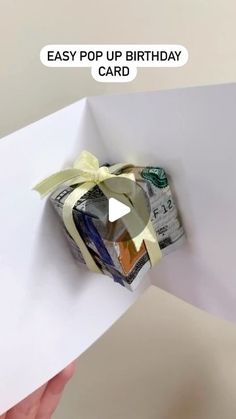 someone is holding up a birthday card with money in it and the words easy pop up birthday card