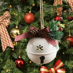 a christmas ornament hanging from the side of a tree with ornaments around it