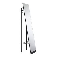 a tall mirror is standing on a metal stand