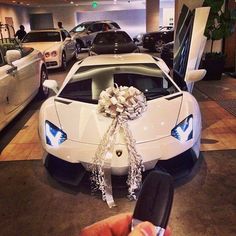 a white sports car with a ribbon tied to it's hood and the words, birthday present?