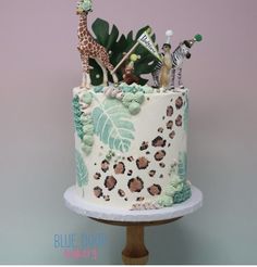 there is a cake decorated with animals and plants