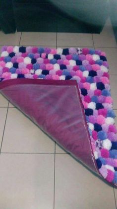 a pink and purple rug on the floor