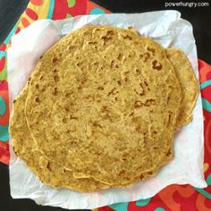 two tortillas sitting on top of a colorful napkin