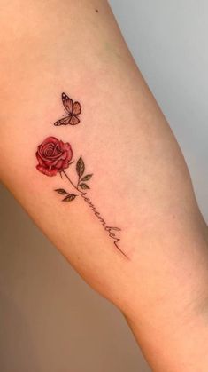 a rose and butterfly tattoo on the right arm with words written in cursive writing