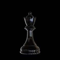 a black glass chess piece on a white background