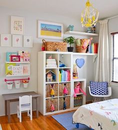 a child's bedroom with toys and decor on the walls, including bookshelves