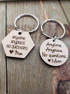 two keychains with words on them that say, anytime no questions and no questions mom